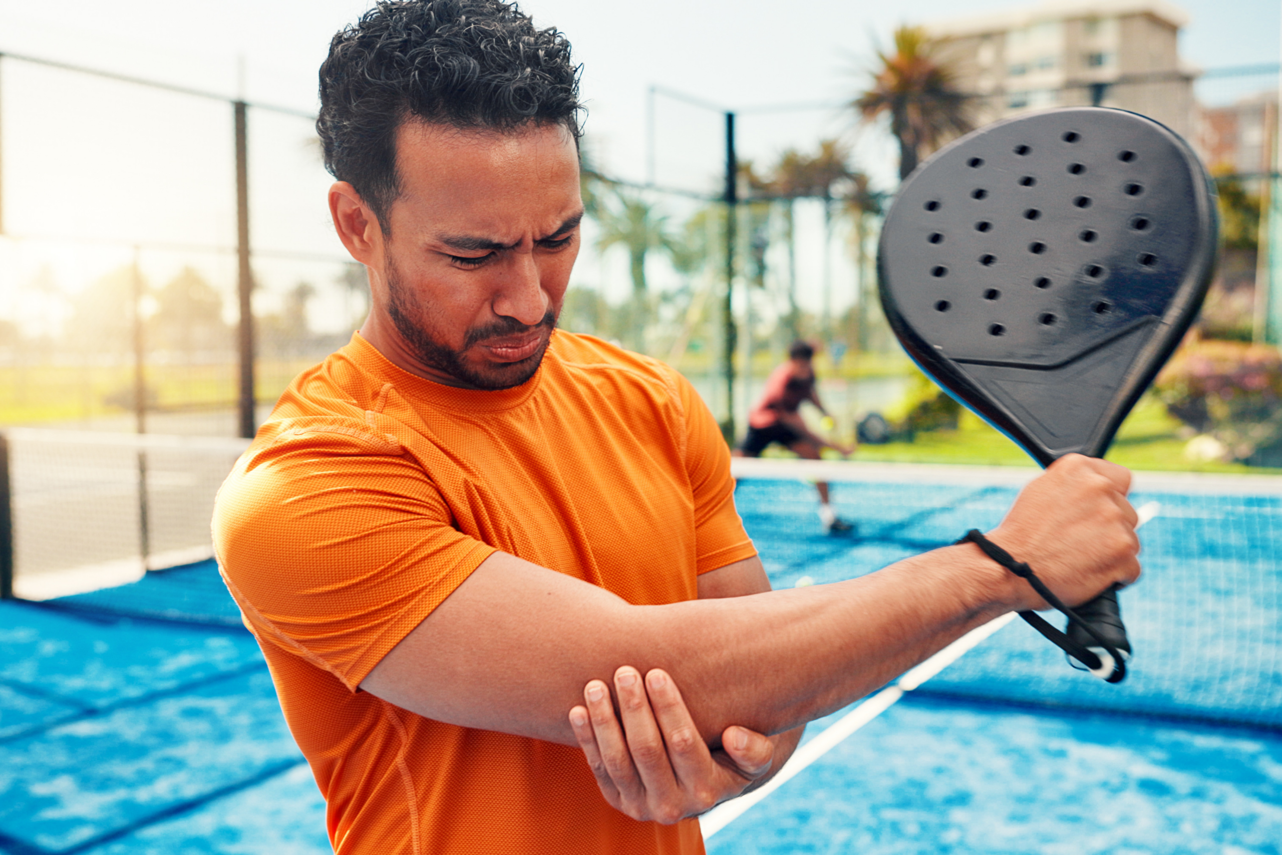 man playing a sport injures his arm